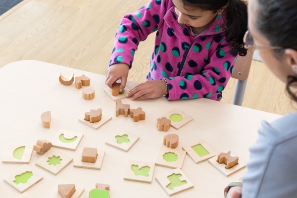 Child learning with stamps and shapes